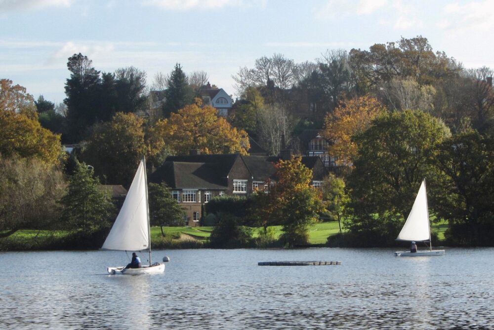 Sailing boats looking across the lake to the golf club house, 17 November 2021